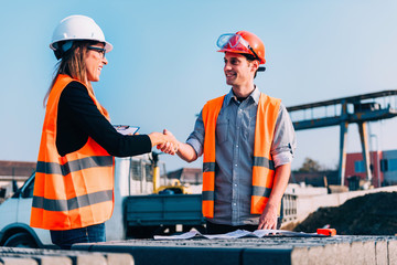 Handshaking on construction site. Business people handshaking on construction site