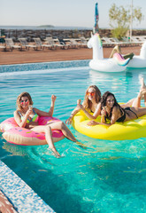 Friends in sunglasses eating ice cream at the pool. 20s.