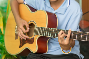 Fototapeta na wymiar A boy playing guitar