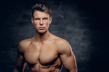 Fototapeta premium Shirtless sporty male on grey background.