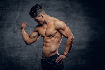 Fototapeta na wymiar Shirtless athletic male showing biceps.