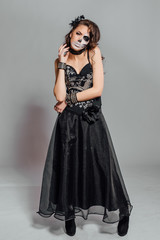 Fototapeta premium Portrait of young woman with skull make-up.