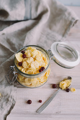 Corn flakes in a jar on light background