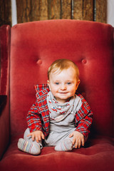 baby reading a book on back and sitting in couch, chair