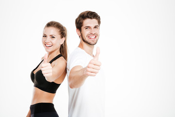 Man and woman showing thumbs up gesture