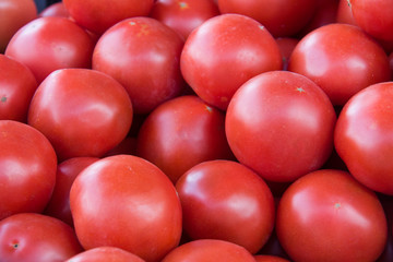 red tomatoes sold on the a market counter