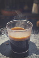 cup of fresh coffee espresso with steam, retro toned