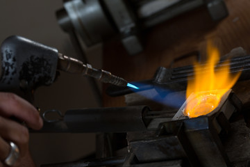 Metal Casting from Crucible to Metal Mold with blowtorch; Goldsmith Workshop; Close-up
