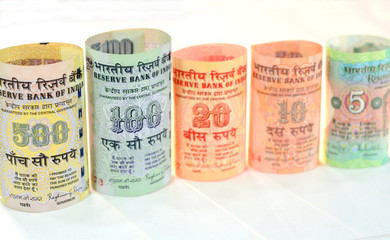 Indian currency notes on a white background.