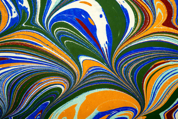 Fototapeta na wymiar Ebru art. Traditional Turkish Ebru technique. Painting on water, followed by paper prints. Color paint ebru with waves and tile pattern.