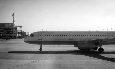 Passenger plane heading to the airport. Black and white.