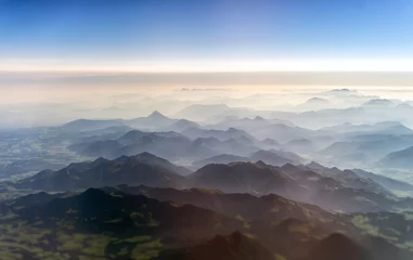 Foto op Plexiglas Luchtfoto van de bergen in de wolken. © M-Production