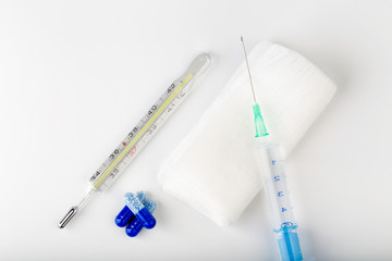 Syringe, pill and thermometer