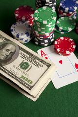 Dollar bills, playing cards and poker chips