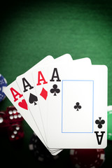 Playing cards, poker chips, and dices on green table