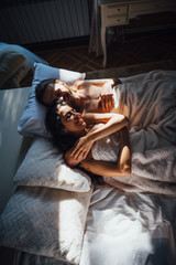 bride and groom lying in bed