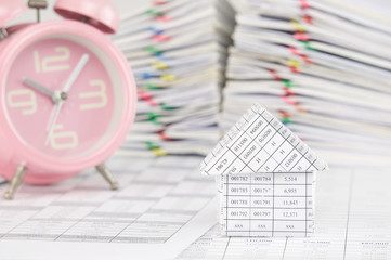 House have blur old pink alarm clock and pile paperwork