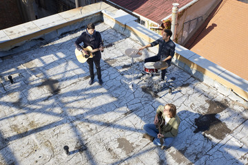 Music band playing music. Full length shot of a pop band playing music on outdoor scene. 