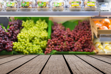 Wooden table and blurred image of shelf in supermarket