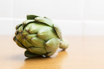 Fototapeta premium Green artichoke on the table