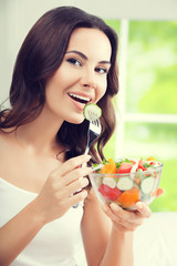 beautiful woman eating salad, indoor
