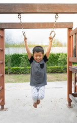 Fototapeta premium Asian boy playing on playground