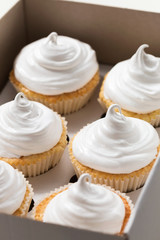 Vanilla cupcakes with white cream, cupcake packaging, delivery box,, selective focus, close up