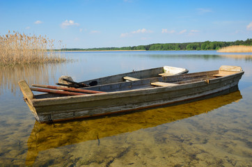Transparent lake with small wooden boats