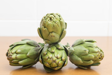 Obraz premium four artichokes forming a dynamic set