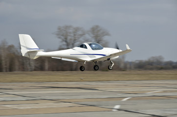A light aircraft above runway