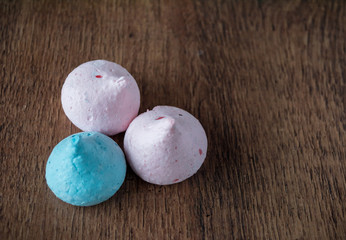 Cookies Meringue pink and blue. Wooden background.