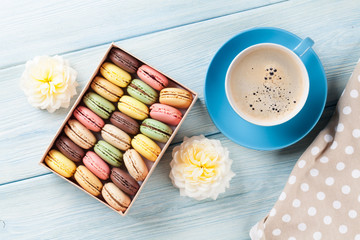 Colorful macaroons, coffee. Sweet macarons