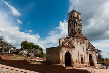 Fototapeta na wymiar Old colonial church on a square in Trinidad, Cuba, with a sunny
