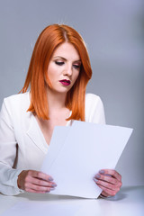 Concerned business woman reading papers