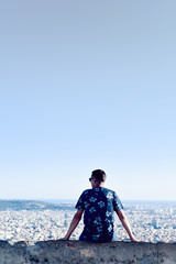 Fototapeta premium young man with the city bellow him