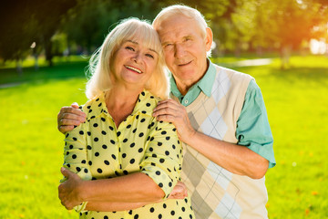 Older couple outdoors. Smiling woman with man. Always support each other. Together in happiness and grief.