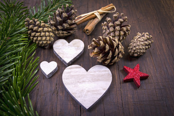 Christmas decoration is placed ready: pine cones, hearts, red st