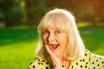Amazed woman with open mouth. Female holding hand on cheek. Winner of the lottery. My life changed...