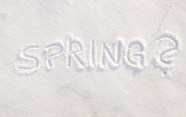 Word spring? scribbled in snow - concept of being tired of cold weather, ready for spring to arrive
