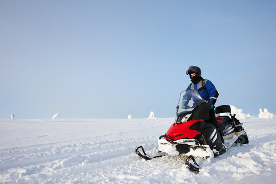 Man driving snowmobile in Finland