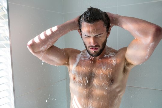 Man Taking A Bath In Bathroom