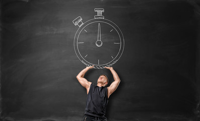 Muscular sportsman holding up big timer, drawn on the blackboard.