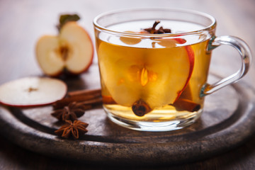 Apple Cider Drink,Juice,Cider with Spices ,Cinnamon sticks and fresh Apples.Hot drink for Autumn and Winter Christmas evenings.selective focus.