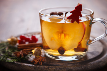 Apple Cider Drink,Juice,Cider with Spices ,Cinnamon sticks and fresh Apples.Hot drink for Autumn and Winter Christmas evenings.selective focus.
