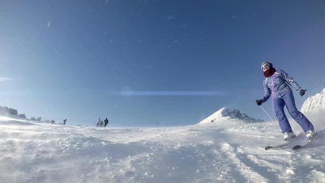 Female Skier splashing goes beside the camera slow motion video
