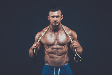 Fototapeta na wymiar Muscular man skipping rope. active sport fitness 