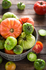 Colorful organic tomatoes on wooden table 