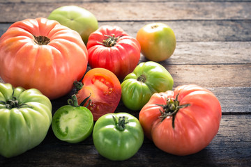 Colorful organic tomatoes on wooden table 