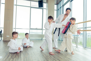 Fototapeta premium young, beautiful, successful multi ethical kids in karate positi
