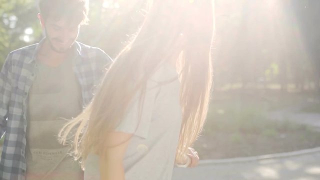 Young man and woman having fun with Hoverboard in the park. Content technologies. a new movement. Close Up of Dual Wheel Self Balancing Electric Skateboard Smart